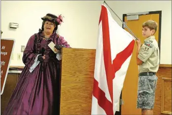  ?? Natasha Colbaugh /
NPCO ?? Pat Silcox introduces the flags from the 20 states that fought in the Battle of Chickamaug­a. From Boy Scout Troop 52 is Nick Brite holding the Alabama state flag.