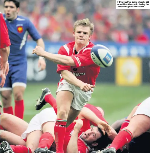  ??  ?? > Dwayne Peel doing what he did so well in a Wales shirt during the 2005 win against the French