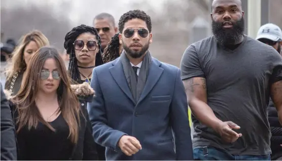  ?? ASHLEE REZIN/SUN-TIMES PHOTOS ?? Actor Jussie Smollett walks with supporters into the Leighton Criminal Court Building on Thursday.