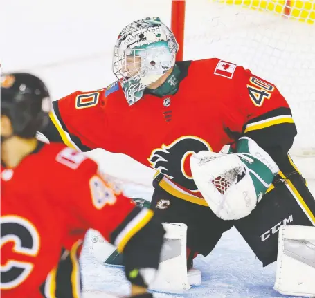  ?? AL CHAREST ?? Flames prospect Dustin Wolf reaches for a save against the Edmonton Oilers during the Battle of Alberta prospects game at Scotiabank Saddledome on Tuesday night. Eighteen-year-old Wolf is an undersized goalie at six feet, 165 pounds.