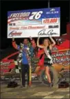  ?? SUBMITTED PHOTO - RICK KEPNER ?? Jeff Strunk, left, lifts the winner’s check alongside Miss Grandview after winning the Freedom 76 Classic Saturday night at Grandview Speedway.