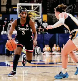  ?? Aaron Gash/Associated Press ?? UConn’s Aaliyah Edwards (3) drives to the basket against Marquette’s Chloe Marotta during the first half on Wednesday.