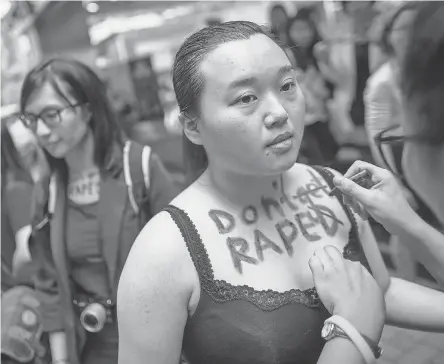  ??  ?? A participan­t in the Hong Kong SlutWalk has the words “Don’t get raped” written on her chest. The rally was held to condemn sexual, gender and body-based violence. JEROME FAVRE/EUROPEAN PRESSPHOTO AGENCY