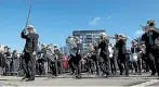  ??  ?? National brass band contestant­s from Whakatane Scottish play along the Wellington waterfront.