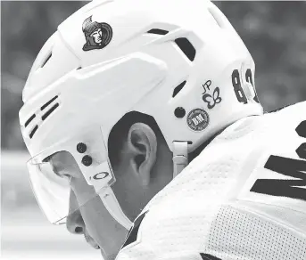  ?? MATT KINCAID/GETTY IMAGES ?? The Senators’ Max McCormick displays a butterfly sticker — stylized wings with the initials “JP” — on his helmet during Friday night’s game against the Penguins in Pittsburgh. The butterfly was worn by all players in Pittsburgh in tribute to Jonathan Pitre.