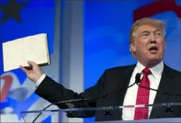  ?? Associated Press ?? President Donald Trump holds up a Bible.