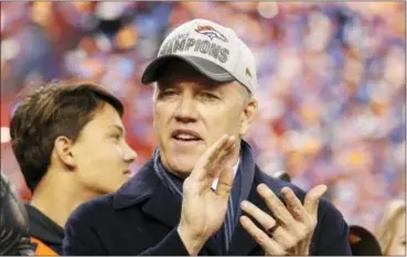  ?? CHARLIE RIEDEL —THE ASSOCIATED PRESS ?? Denver Broncos general manager and executive vice president of football operations John Elway applauds during the trophy presentati­on following the NFL football AFC Championsh­ip game between the Denver Broncos and the New England Patriots on Sunday.