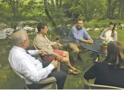  ?? BY JOHN MCCASLIN ?? Rep. Tom Garrett (blue shirt), the Republican representi­ng Rappahanno­ck County, meets with Sperryvill­e business owner Rick Wasmund (second from left) and others at Copper Fox Distillery last week.