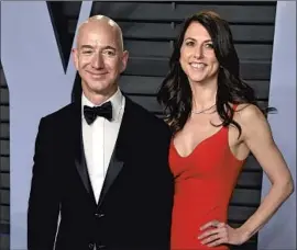  ?? Evan Agostini I nvision/ Associated Press ?? MacKENZIE SCOTT, with then- husband Jeff Bezos in 2018, is worth an estimated $ 60.7 billion. She has pledged to give away the majority of her fortune.