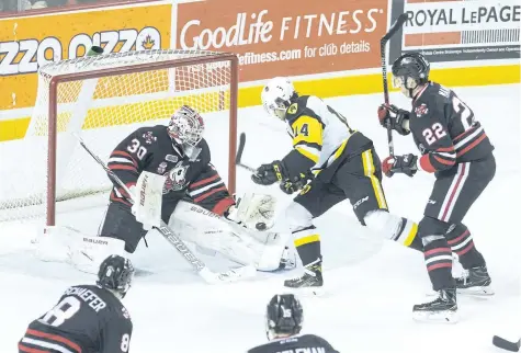  ?? JULIE JOCSAK/STANDARD STAFF ?? Goalie Stephen Dhillon of the Niagara IceDogs defends the net against Niki Petti the Hamilton Bulldogs in OHL action at the Meridian Centre in downtown St. Catharines on Friday.