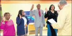  ?? CAROLE CARLSON/POST-TRIBUNE ?? School district attorney Robert Lewis swears in three new Gary school board members Tuesday and the board’s president: Mary Ann Canty-Reedus, from left, Serita Jackson, board President Robert Buggs and Larona Carter.