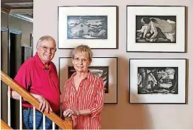  ?? [PHOTO BY MATT BARNARD, TULSA WORLD] ?? Kent and Jeanette Young display artwork by Doel Reed.