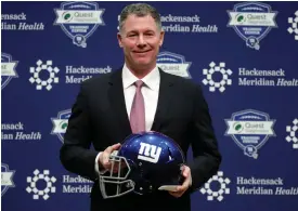  ??  ?? Pat Shurmur with the Giants helmet after being introduced as the head coach.