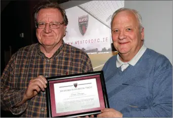  ??  ?? Frank Flanagan receiving the first-ever share certificat­e from club Secretary Terry Cooke.