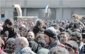  ?? SANA THE ASSOCIATED PRESS ?? Syrian civilians with their belongings flee fighting between Syrian government forces and rebels near Hamouria in eastern Ghouta, a suburb of Damascus, Syria, on Friday.