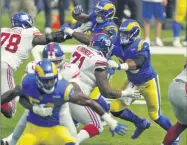  ?? ASHLEY LANDIS - THE ASSOCIATED PRESS ?? Los Angeles Rams defensive end Aaron Donald, center, works against the New York Giants during the first half of an NFL football game Sunday, Oct. 4, 2020, in Inglewood, Calif.