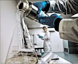  ?? VERNON BRYANT/THE DALLAS MORNING NEWS ?? David Stermer, center, works on making terpenes as project manager Darius Bonds, foreground, works on making super lemon haze terpene at Ricca Chemical in Arlington, Texas.