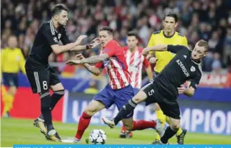  ??  ?? MADRID: Atletico’s Fernando Torres, center, tries to break through the Qarabag defence during a Group C Champions League soccer match between Atletico Madrid and Qarabag at the Metropolit­ano stadium in Madrid. — AP