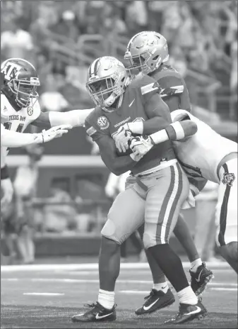  ?? NWA Democrat-Gazette/BEN GOFF ?? Arkansas running back David Williams (center) breaks away from Texas A&M’s Keldrick Carper (left) and Larry Pryor as he crosses the goal line Saturday at AT&T Stadium in Arlington, Texas.