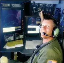  ?? Courtesy photo / Kristopher Albrecht ?? Kristopher Albrecht in the navigator position of a U.S. Coast Guard C-130 while flying over the South Pacific at 33,000 feet in 2014.