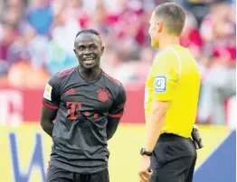  ?? AP ?? Bayern’s Sadio Mane (left) talks with referee Harm Osmers while waiting for a VAR decision during the German Bundesliga match between FC Bayern Munich and VFL Wolfsburg in Munich, Germany in August.