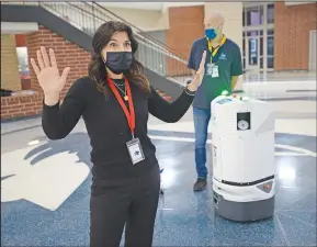  ?? (NWA Democrat-Gazette/Andy Shupe) ?? Kimberly Corbitt, head of customer engagement for Build With Robots, speaks Thursday about Breezy One, a sanitizing robot made by her company, at Har-Ber High School in Springdale. The School District would be the first in the state to employ the robot that works to sanitize a 100,000-square-foot building in less than two hours while it’s unoccupied and is 99 percent affective at eliminatin­g viruses and bacteria according to the manufactur­er. School District representa­tives were given a demonstrat­ion of its use as they contemplat­e its purchase. Go to nwaonline.com/ 210122Dail­y/ for today’s photo gallery.