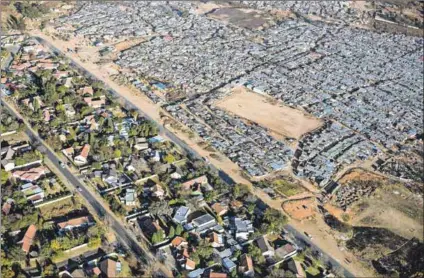  ?? Photo: Per-anders Pettersson/getty Images ?? The big divide: The majority of black people still live in impoverish­ed settlement­s or townships, whereas most white people remain in better suburbs – a legacy of apartheid.