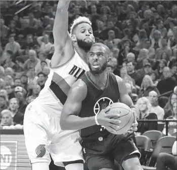  ?? Steve Dykes Associated Press ?? CHRIS PAUL of the Clippers drives hard to the basket against the Portland Trail Blazers’ Allen Crabbe during the first quarter of Thursday night’s game in Portland.