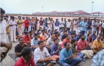  ?? — PTI ?? Protesters block the arrival gate of the domestic terminal after women’s rights activist Trupti Desai arrived at the Cochin Internatio­nal Airport to visit the Sabarimala temple in Kochi on Friday.