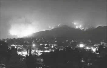  ?? ASSOCIATED PRESS ?? IN THIS AUG. 31, 2009, FILE PHOTO, Angeles in the Station fire. wildfires rage on the hillsides of the Tujunga area of Los