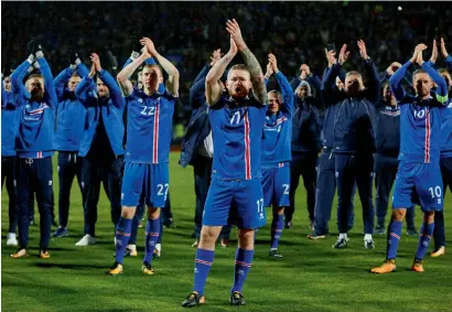  ?? AP ?? Iceland’s captain Aron Gunnarsson leads his teammates enact the famous Viking Clap at the end of their World Cup Group I qualifying match against Kosovo in Reykjavik, Iceland on Monday. —