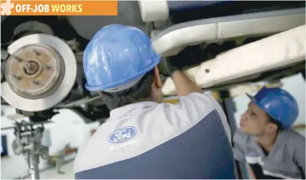  ?? — Reuters ?? The corporate logo of Ford is seen on the uniform of a mechanic at a Ford branch in Caracas, Venezuela.