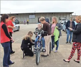  ?? / Alexis Draut ?? Advance for Kids’s physical therapists help Zachary Cagle get adjusted in his new custom bike donated to his family by Freedom Concepts on Thursday. Above right: Isabella Funes, 6, gets adjusted in her new custom-made bike by Freedom Concepts Manager Jaydene Lowe, who presented the Funes family with the bike.