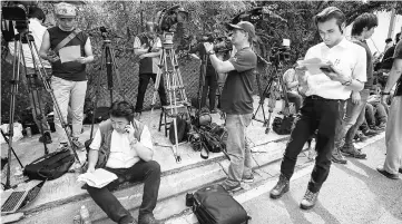  ??  ?? Members of the media reading a press release distribute­d by North Korean Embassy in Kuala Lumpur. — Bernama photo