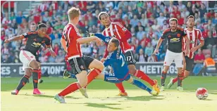  ?? REUTERS
Photo: ?? New signing Anthony Martial, left, scores Manchester United’s equaliser in their 3-1 win at Southampto­n.