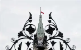  ?? ADRIAN WYLD THE CANADIAN PRESS FILE PHOTO ?? The Canadian flag flew at half mast for months after the discovery of unmarked graves at a B.C. residentia­l school last year.
