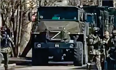  ?? ?? OCCUPIERS: Russian troops and armoured vehicles in the streets of the southern Ukraine city of Kherson
