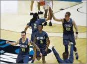  ?? ROBERT FRANKLIN — THE ASSOCIATED PRESS ?? Oral Roberts players celebrate after beating Ohio State in a first-round game in the NCAA tournament Friday at Mackey Arena in West Lafayette, Ind.