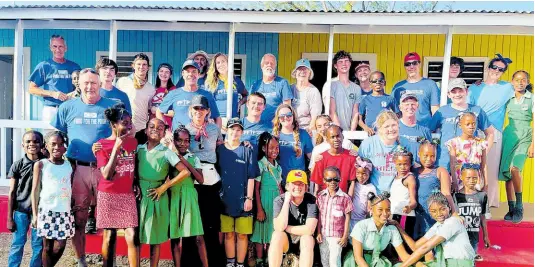  ?? CONTRIBUTE­D PHOTOS ?? After forming lasting bonds with the Portland Cottage Primary School community during the renovation project over the weekend of February 17-18, donors and volunteers with the Davitt/Ruppert mission group were excited to capture the memories during a group photo with some of the students of the school.