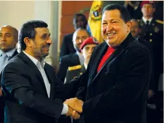  ?? (Reuters/Jorge Silva) ?? HUGO CHAVEZ, welcomes Iran’s Mahmoud Ahmadineja­d, to Miraflores Palace in Caracas, in June 2012, when both men served as president of Venezuela and Iran, respective­ly.