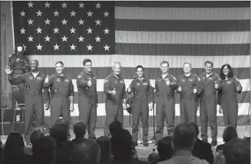  ?? ASSOCIATED PRESS ?? ASTRONAUTS (FROM LEFT TO RIGHT) VICTOR GLOVER, MICHAEL HOPKINS, Robert Behnken, Douglas Hurley, Nicole Mann, Christophe­r Ferguson, Eric Boe, Josh Cassada and Sunita Williams give a thumbs up to the crowd after NASA announced them as astronauts assigned...