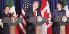  ?? MARTIN MEJIA AP ?? Flanked by Mexican President Enrique Peña Nieto, left, and Canadian Prime Minister Justin Trudeau, President Donald Trump smiles during a signing ceremony of their trade agreement on the sidelines of the Group of 20 summit in Buenos Aires, Argentina, on Nov. 30. To take effect, the United States-Mexico-Canada Agreement must still be approved by lawmakers in all three countries.