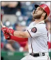  ?? AP/NICK WASS ?? Bryce Harper of the Washington Nationals watches his 10th inning sacrifice fly that allowed pinch-runner Michael Taylor to score the winning run in a 4-3 victory over the St. Louis Cardinals on Monday in Washington.