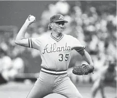  ?? AP PHOTO/ RUSTY KENNEDY ?? Phil Niekro pitches against the host St. Louis Cardinals during the National League Championsh­ip Series at Busch Stadium on Oct, 6, 1982.