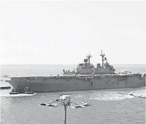  ?? KATE CIMINI/MEDILL NEWS SERVICE ?? The USS Kearsarge pulls away from Naval Station Norfolk docks in Virginia. Much of the base is less than 10 feet above sea level.