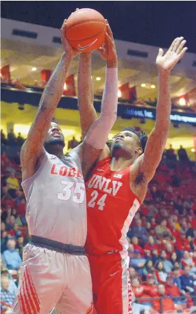  ?? GREG SORBER/JOURNAL ?? UNM’s Carlton Bragg (35) shoots over UNLV’s Joel Ntambwe during the Lobos’ 80-69 loss Tuesday in the Pit.