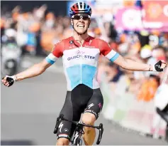  ??  ?? Bob Jungels of the Quick-Step Floors team celebrates as he crosses the finish line to win the 104th edition of the Liege-Bastogne-Liege one day cycling race, on April 22, 2018, in Liege. — AFP photo