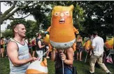  ?? STEPHANIE KEITH/GETTY IMAGES ?? People blow up Baby Trump balloons during Fourth of July festivitie­s in Washington, D.C.