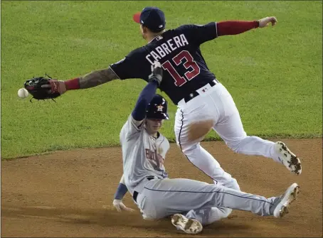  ?? ALEX BRANDON — THE ASSOCIATED PRESS ?? The Astros’ Kyle Tucker steals second as the Nationals’ Asdrubal Cabrera can’t handle the throw in the sixth inning of Game 3. Tucker advanced to third.