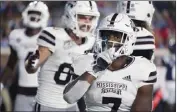  ?? ROGELIO V. SOLIS — THE ASSOCIATED PRESS ?? Mississipp­i State running back Jo'quavious Marks gestures after scoring on a 1-yard touchdown run Thursday night.